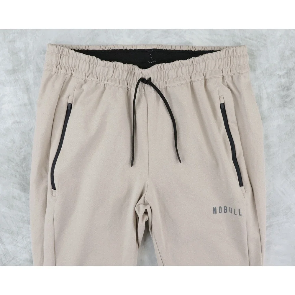 NOBULL Jogger Pants Mens Medium Tan Zipper Pockets Tapered Training Sweatpants